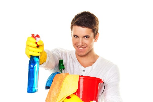 Staff member using protective gloves while handling cleaning products